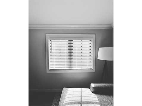Hanging blinds in a grey room